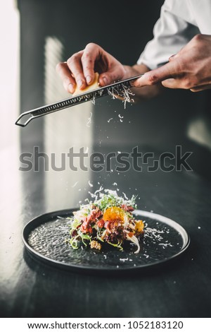 Star Chef Grate Cheese On Top Of Fresh Food Dark Table Star Chef Grate Cheese On Top Of Fresh Food Dark Table