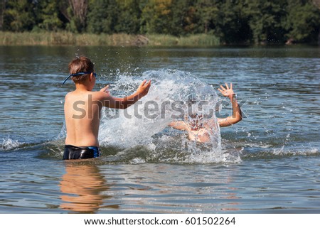 Kids Swimming In A Lake swimming lake stock images, royalty-free images & vectors Kids Swimming In A Lake swimming lake stock images, royalty-free images & vectors
