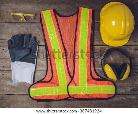Standard construction safety equipment on wooden table. top view