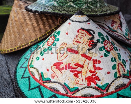Colorful traditional conical hat with a special design sold at a small shop in Bali, Indonesia