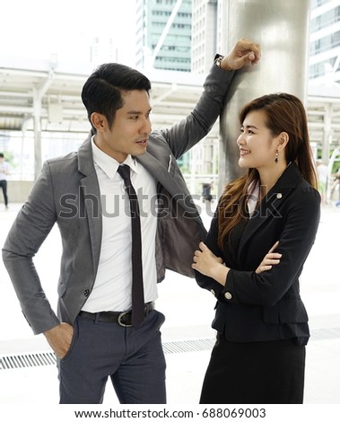 https://thumb1.shutterstock.com/display_pic_with_logo/169790252/688069003/stock-photo-business-man-and-woman-flirting-outdoors-at-front-of-office-close-up-of-workmates-talking-and-688069003.jpg