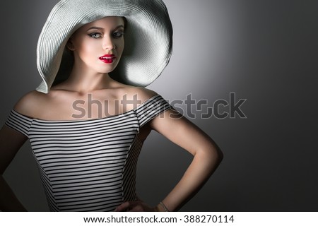 https://thumb1.shutterstock.com/display_pic_with_logo/1700410/388270114/stock-photo-beautiful-woman-in-elegant-hat-with-a-smile-on-his-face-388270114.jpg
