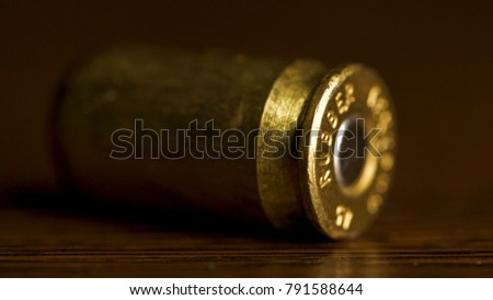 bullet macro with limited dof on a black background, 9mm full metal jacket. Bullet isolated on black background with reflexion. close up gun bullets. Weapon Cartridge case sleeve background texture