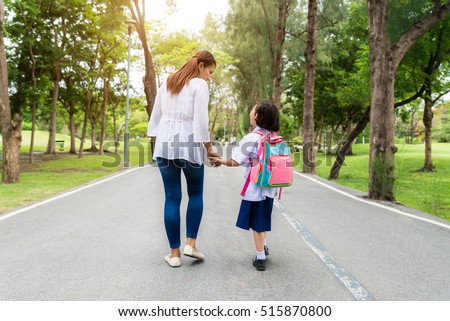 Asian mother and daughter student walking to school.Pupil student.