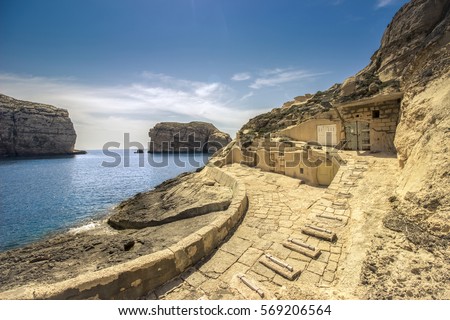 stock-photo-landscape-with-mediterranean-sea-in-malta-rocky-bay-and-hidden-boat-house-569206564.jpg