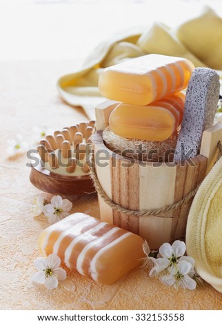 bars of glycerin soap and hygiene items on a yellow background. health care and hygiene concept. selective focus