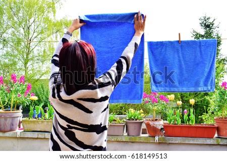 https://thumb1.shutterstock.com/display_pic_with_logo/171213068/618149513/stock-photo-asian-woman-hanging-towel-to-dry-on-clothesline-after-laundry-in-the-sun-on-blur-nature-background-618149513.jpg