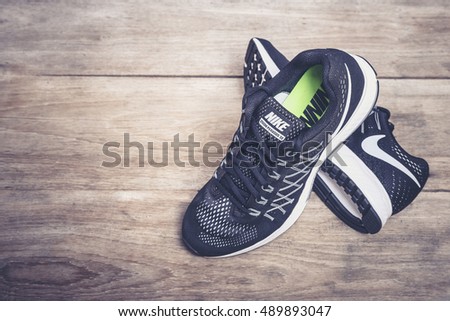 PHUKET, THAILAND - MARCH 6 : New style nike shoes. Taken at studio on wooden plank on March 6, 2016 in Phuket, Thailand. Nike is one of the world's largest suppliers of athletic shoes and apparel.