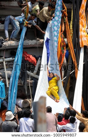 DHAKA, BANGLADESH - APRIL 24, 2013: Rescue workers try rescue trapped garment workers in the Rana plaza building which collapsed in Saver near Dhaka, Bangladesh on April 24, 2013.