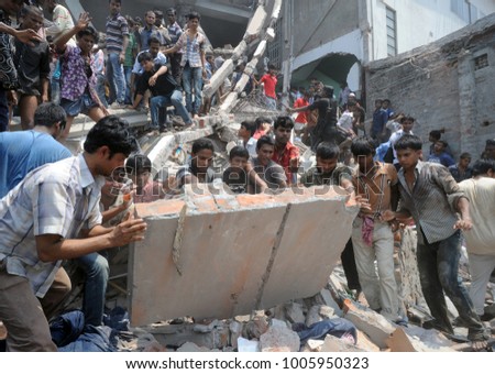 DHAKA, BANGLADESH - APRIL 24, 2013: Rescue workers try rescue trapped garment workers in the Rana plaza building which collapsed in Saver near Dhaka, Bangladesh on April 24, 2013.