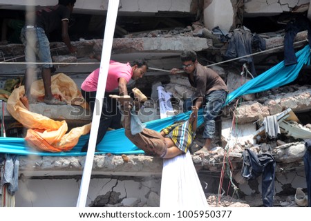 DHAKA, BANGLADESH - APRIL 24, 2013: Rescue workers try rescue trapped garment workers in the Rana plaza building which collapsed in Saver near Dhaka, Bangladesh on April 24, 2013.
