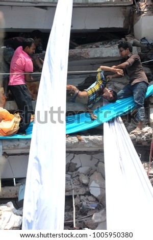 DHAKA, BANGLADESH - APRIL 24, 2013: Rescue workers try rescue trapped garment workers in the Rana plaza building which collapsed in Saver near Dhaka, Bangladesh on April 24, 2013.