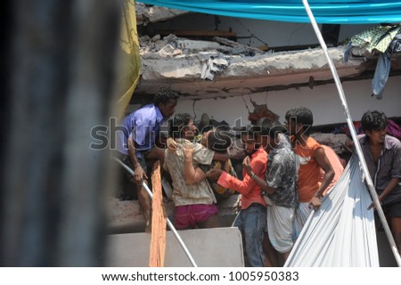 DHAKA, BANGLADESH - APRIL 24, 2013: Rescue workers try rescue trapped garment workers in the Rana plaza building which collapsed in Saver near Dhaka, Bangladesh on April 24, 2013.