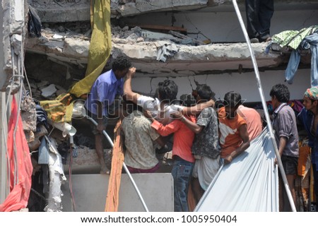 DHAKA, BANGLADESH - APRIL 24, 2013: Rescue workers try rescue trapped garment workers in the Rana plaza building which collapsed in Saver near Dhaka, Bangladesh on April 24, 2013.