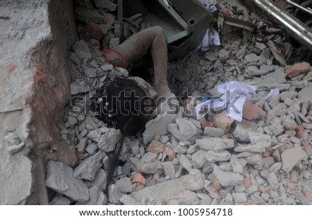 DHAKA, BANGLADESH - APRIL 24, 2013: Rescue workers try rescue trapped garment workers in the Rana plaza building which collapsed in Saver near Dhaka, Bangladesh on April 24, 2013.