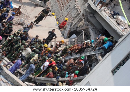 DHAKA, BANGLADESH - APRIL 24, 2013: Rescue workers try rescue trapped garment workers in the Rana plaza building which collapsed in Saver near Dhaka, Bangladesh on April 24, 2013.