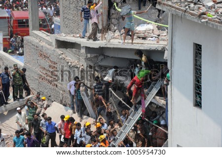 DHAKA, BANGLADESH - APRIL 24, 2013: Rescue workers try rescue trapped garment workers in the Rana plaza building which collapsed in Saver near Dhaka, Bangladesh on April 24, 2013.