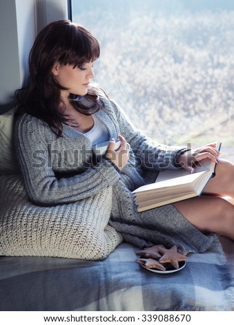 https://thumb1.shutterstock.com/display_pic_with_logo/174604/339088670/stock-photo-young-beautiful-brunette-woman-with-cup-of-coffee-and-gingerbread-wearing-knitted-cardigan-reading-339088670.jpg