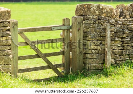 Countryside View And Rustic Gate In Drystone Wall Village Bibury England Countryside View And Rustic Gate In Drystone Wall Village Bibury England