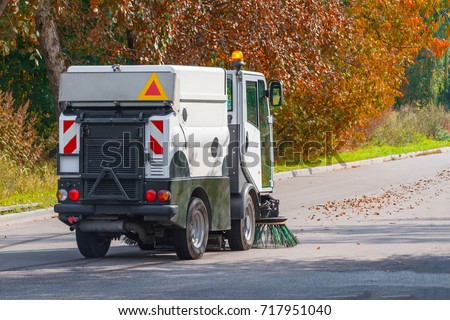 street cleaning machine on the background of the autumn park