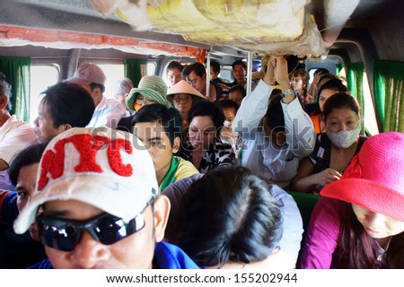 CA MAU, VIET NAM- JUNE 29, 2013. People sit in overcrowded, packed like sardines with number of passenger over assign, they look unhappy on non-stop express passenger boat. June 29, 2013