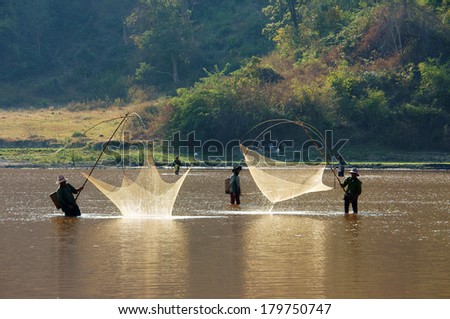 BUON ME THUOT, VIETNAM- FEB 7: People catch fish on ditch, fisherman lifting net from water, lift net is primitive traditional tool, include net, rod, four corner hang up 4 frame, Vietnam, Feb 7, 2014