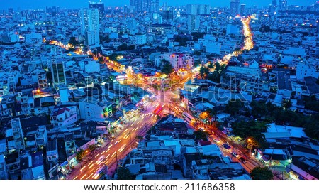 HO CHI MINH, VIETNAM- AUG 14: Amazing panaromic of Asia city, block of house close together, vehicle make yellow trail on street, impression intersection, Sai gon is big town, Vietnam, Aug 14, 2014