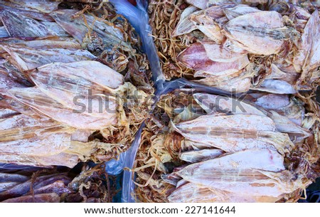 Dried shredded squid is a dried, seafood product, made from squid or cuttlefish, commonly found in coastal Asian, show at Vietnam open air market, is popular street snack