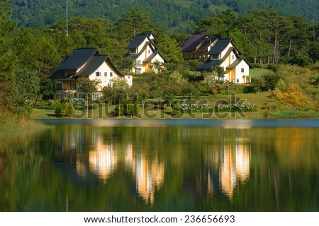 Beautiful landscape at Dalat village, group of villas reflect on lake, eco holiday resort among green pine forest, fresh air, pure environment, romantic scene for honeymoon at Da Lat, Vietnam