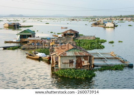 DONG NAI, VIET NAM- FEB 28: Life of Asian fisherman on La Nga river, group of floating house in residence of fishing village, people make living by aquaculture, river fish, Vietnam, Feb 28, 2015
