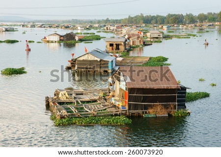 DONG NAI, VIET NAM- FEB 28: Life of Asian fisherman on La Nga river, group of floating house in residence of fishing village, people make living by aquaculture, river fish, Vietnam, Feb 28, 2015