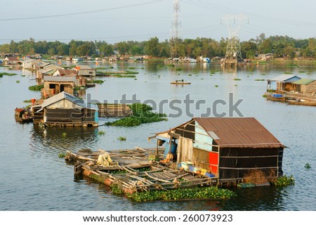 DONG NAI, VIET NAM- FEB 28: Life of Asian fisherman on La Nga river, group of floating house in residence of fishing village, people make living by aquaculture, river fish, Vietnam, Feb 28, 2015
