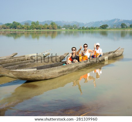 BUON ME THUOT, VIET NAM- FEB 25: Traveller travelling on Lak Lake, caucasian tourist on rowing boat, wear life jacket, people happy with view at nature, Buonmethuot, Vietnam, Feb 25, 2015