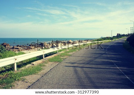Beautiful scene of Viet Nam coastal, boundary among beach and road, wonderful landscape at Vietnamese countryside, shadow on street, this view at Lagi, Binh Thuan, VietNam