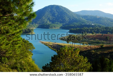 Tuyen Lam lake at Dalat, Vietnam, beautiful landscape for eco travel at Viet Nam, amazing lake among pine forest make wonderful scene, boat on water, Da Lat countryside is famous place for holiday
