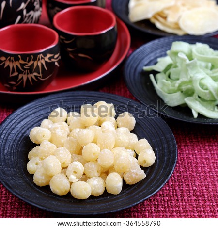 Vietnamese food for Tet holiday in spring, jam is traditional food on lunar new year, can make from sweet potato, lotus seed, ginger with sugar, colorful background for Vietnam custom