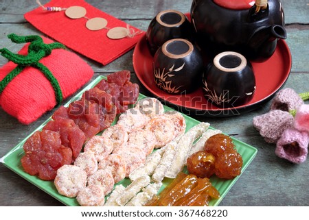 Amazing of Vietnamese food for Tet holiday in spring, jam is traditional food on lunar new year, make from sweet potato, lotus seed, ginger, mango with sugar, colorful background for Vietnam culture