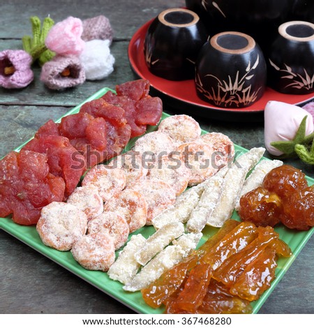 Amazing of Vietnamese food for Tet holiday in spring, jam is traditional food on lunar new year, make from sweet potato, lotus seed, ginger, mango with sugar, colorful background for Vietnam culture