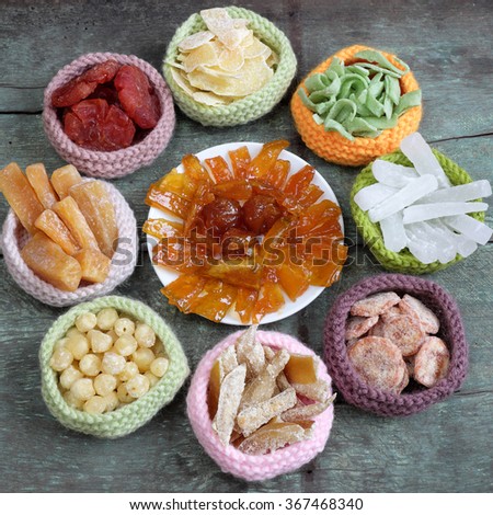 Amazing of Vietnamese food for Tet holiday in spring, jam is traditional food on lunar new year, make from sweet potato, lotus seed, ginger, mango with sugar, colorful background for Vietnam culture