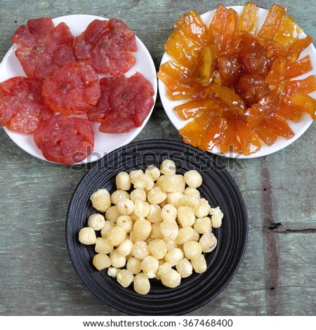 Amazing of Vietnamese food for Tet holiday in spring, jam is traditional food on lunar new year, make from sweet potato, lotus seed, ginger, mango with sugar, colorful background for Vietnam culture