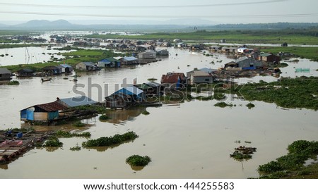 DONG NAI, VIET NAM- JUNE 5: Group of floating house on La Nga fishing village, river with green grass and hyacinth, residence of people who live with fish farming at Dongnai, Vietnam