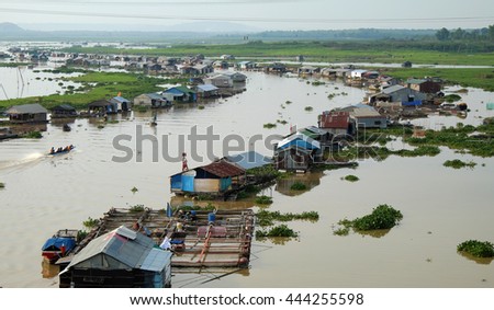DONG NAI, VIET NAM- JUNE 5: Group of floating house on La Nga fishing village, river with green grass and hyacinth, residence of people who live with fish farming at Dongnai, Vietnam
