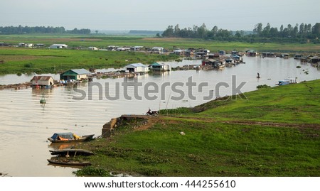 DONG NAI, VIET NAM- JUNE 5: Group of floating house on La Nga fishing village, river with green grass and hyacinth, residence of people who live with fish farming at Dongnai, Vietnam