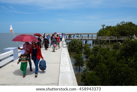 CA MAU, VIET NAM- JULY 16, 2016: Group of tourist travelling Dat Mui, a geography place people walking on breakwater along the beach