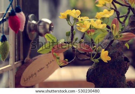 Happy new year with spring flower and wood banner on white background, amazing yellow apricot blossom make from clay, beauty artwork for home decoration in springtime