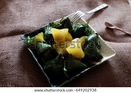 Vietnamese traditional food for may 5th, is double five festival or tet doan ngo, sticky rice cake in green leaf, also call banh u tro with pyramidal shape