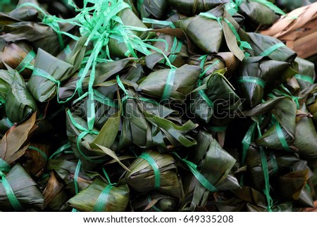 Vietnamese traditional food for may 5th, is double five festival or tet doan ngo, group of sticky rice cake in green leaf, also call banh u tro with pyramidal shape at open air market