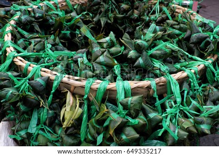 Vietnamese traditional food for may 5th, is double five festival or tet doan ngo, group of sticky rice cake in green leaf, also call banh u tro with pyramidal shape at open air market