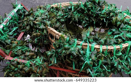 Vietnamese traditional food for may 5th, is double five festival or tet doan ngo, group of sticky rice cake in green leaf, also call banh u tro with pyramidal shape at open air market
