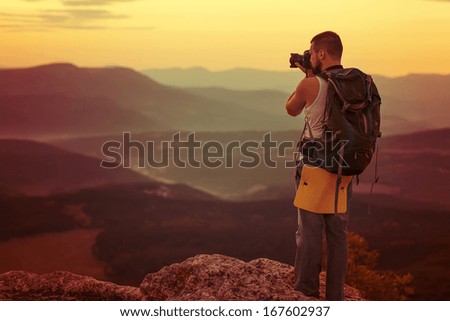 Nature photographer taking photos in the mountains
